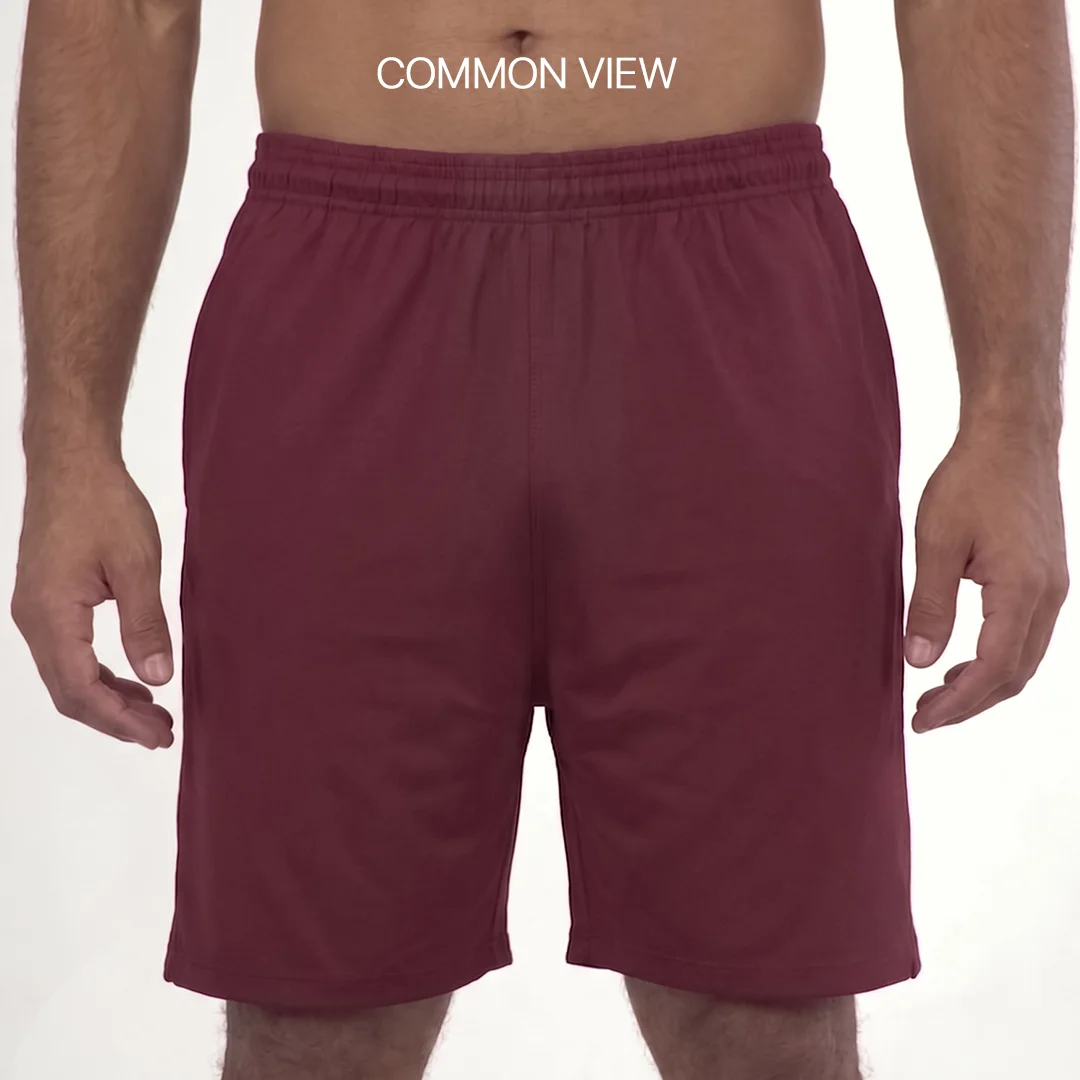 A man wearing B1 classic training shorts featuring 4-way stretch fabric and a comfortable elastic waistband with a drawstring.