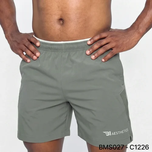 Athlete stretching legs wearing Zipper Pocket Shorts with side contrast panel