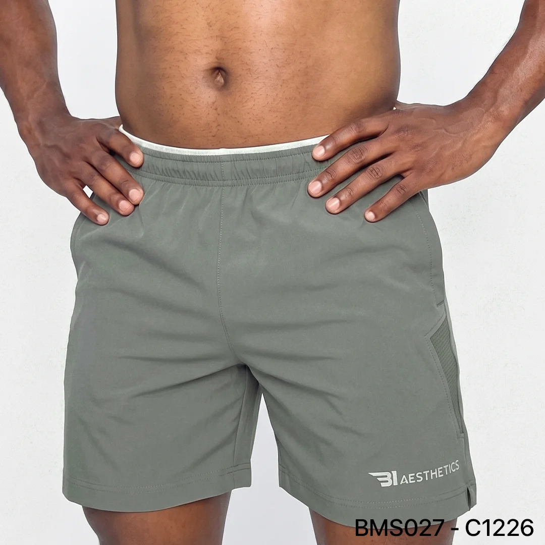 Athlete stretching legs wearing Zipper Pocket Shorts with side contrast panel
