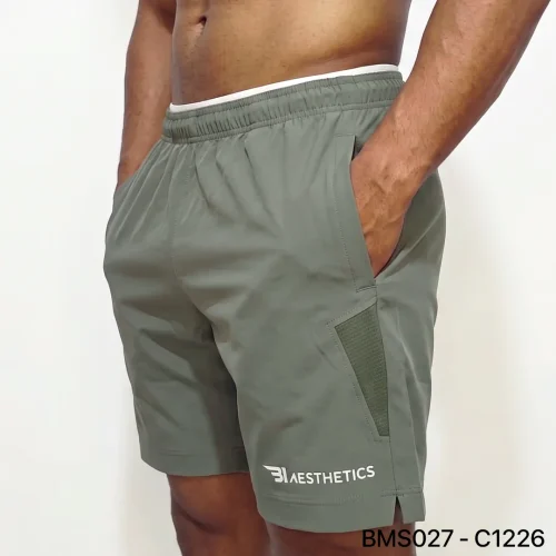 Athlete stretching legs wearing Zipper Pocket Shorts with side contrast panel