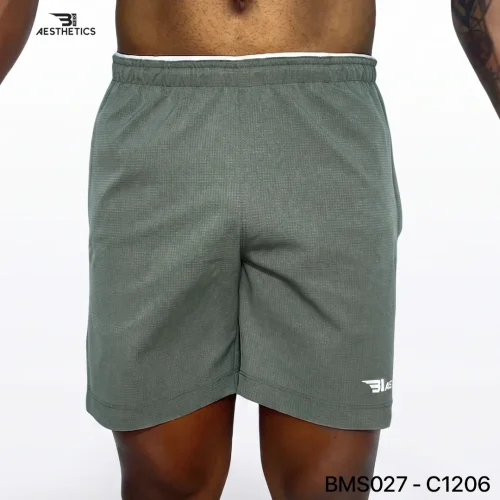 Athlete stretching legs wearing Zipper Pocket Shorts with side contrast panel
