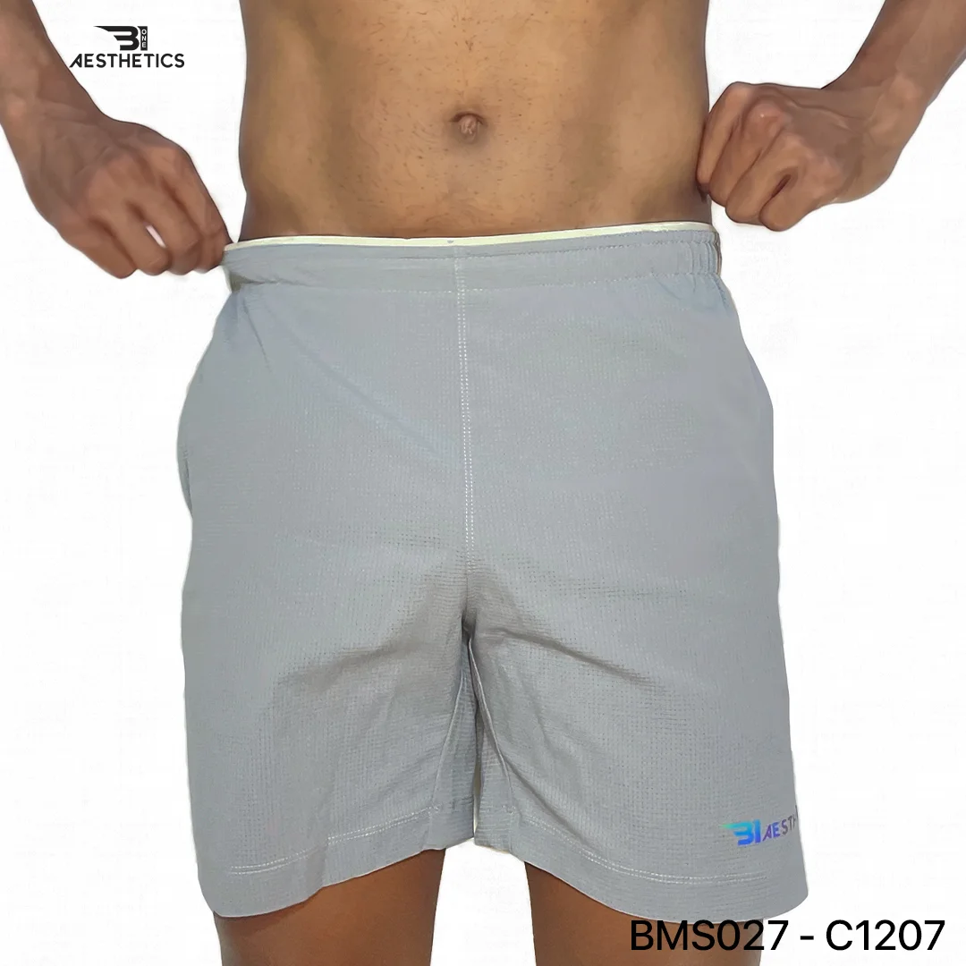 Athlete stretching legs wearing Zipper Pocket Shorts with side contrast panel medium grey