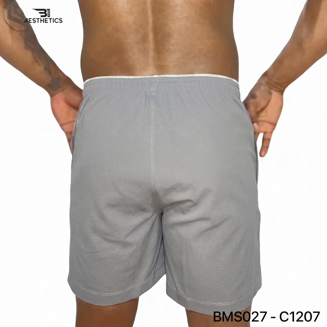Athlete stretching legs wearing Zipper Pocket Shorts with side contrast panel